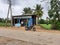 Closeup of small village roadside tea shop or store building with nature,agriculture field background