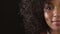 Closeup of smiling afro woman with dimples and a kind, friendly or caring facial expression towards humanity. Half