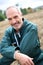 Closeup of smiling farmer kneeling in field