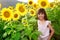 Closeup smiling girl in the sunflowers field