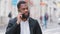 Closeup smiling millennial bearded African American entrepreneur talk to client on phone, share helpful information