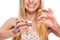 Closeup on smiling teenage girl giving cup of water and pill