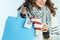 Closeup on smiling trendy woman shopper with bought sweaters