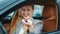 Closeup smiling woman sitting in new car. Happy woman getting keys from new car