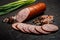 Closeup smoked ham sausage with sliced pieces and green onions