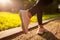 Closeup of sneakers. Young sportive woman running in summer park. Sportswoman jogging.