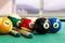Closeup on snooker billards cue, chalk, balls on table