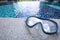 Closeup on Snorkel Mask with swimming pool background.