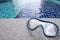 Closeup on Snorkel Mask with swimming pool background.