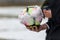 Closeup of snowy soccer ball and the referee`s hand