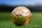 Closeup soccer golden ball on green grass