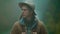 closeup soft focus portrait of man hitchhiker wearing in retro style. traveler in hat with backpack stands outdoors at