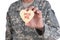 Closeup of a soldier holding a Heart Shaped Valentines Day cookie with the words Hug Me written in red icing