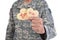 Closeup of a soldier holding two Heart Shaped Valentines Day cookies in one hand with the words Be Mine and XOXO written in red