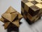 Closeup of a solved cube and star wooden puzzle on a gray surface