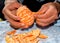 Closeup of someone\'s hands peeling a fresh and delicious tangerine