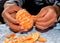 Closeup of someone\'s hands peeling a fresh and delicious tangerine