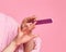 Closeup. Sophisticated young lady teen girl in bathrobe makes manicure with nail file on pink