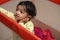 Closeup of a South Asian toddler in a playpen