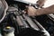 Closeup spanner in hand male mechanic repairs car in garage