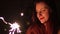 Closeup sparklers portrait of beautiful women celebrating a holiday