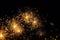 Closeup of sparkling golden fireworks against a
