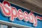 Closeup of Speedy logo on car repair store entry in the street