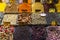 Closeup of spices in containers under the lights in Istanbul Spice Bazaar in Turkey