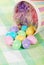 Closeup spilled easter eggs and colorful basket