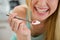 Closeup on spoon with yogurt in hand of girl