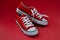 Closeup of sports children sneakers on red background