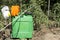 Closeup of spray pump, protective gloves, respirator, cap in the garden.Preparation for spraying tomatoe plants