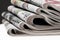 Closeup of stack of newspapers. Assortment of folded newspapers on white. Breaking news, journalism, power of the media,