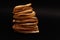 Closeup at stack of sliced dried dehydrated oranges at black background