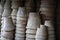 Closeup of stacks of old used weathered terra cotta flower pots in gardening shed