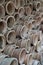 Closeup of stacks of old used weathered terra cotta flower pots in gardening shed