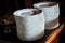 closeup stacks of white round plates on old commode