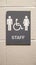 Closeup of staff restroom sign hanging on a white wall