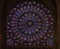 Closeup of stained glass of the oldest rose window installed in 1225 in the Notre Dame de Paris Cathedral in Paris France