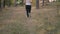 Closeup steadicam shot of female feet in sneakers running in forest