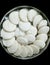 Closeup of steamed rice pancakes in a plate isolated from black  vignettes, food photography, Indian cuisine, rice meals