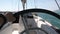 Closeup steering wheel turning round. Sailing boat with waves splashing