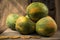 Closeup still photography of fresh papayas on a wooden surface