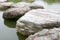 Closeup stone bridge and water pond in park