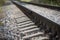 Closeup of straight railways. Selective field of focus. Detail of rusty screws and nut on old railroad track