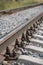 Closeup of straight railways. Selective field of focus. Detail of rusty screws and nut on old railroad track