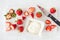 Closeup of Strawberries and Bowl of Whipped Cream on Cutting Board