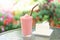 Closeup  strawberry smoothie and milk cake with green nature background, selective focus