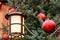 Closeup of street lantern and red christmas balls with LED garland on decorated natural New Year tree
