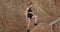 Closeup stretching lady have a workout on wooden steps outside beside the rocks wearing black sportswear enjoys her